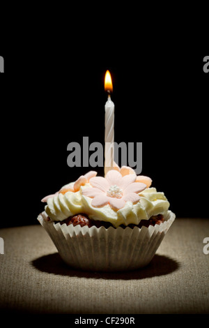 Birthday muffin with small burning candle Stock Photo