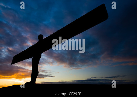 The iconic Angel of the North statue silhouetted against an atmospheric sky. The 'Angel', built on a a former colliery pit head Stock Photo