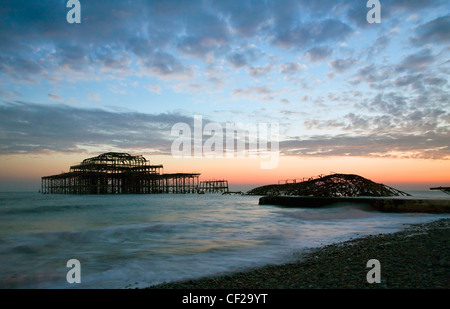 A dramatic winter sunset over the remains of Brightons West Pier. Stock Photo