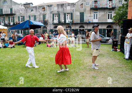 Residents of New Orleans taking part in an outdoor summer Cajun and Zydeco music festival in the city's French Quarter, Louisiana, USA. Stock Photo