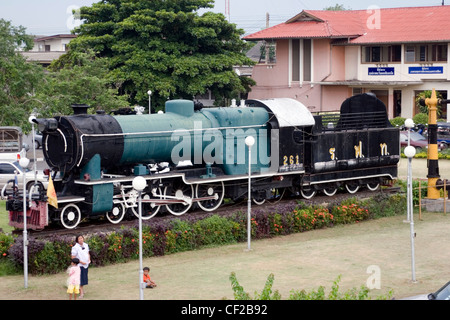 An old steam locomotive is a popular tourist attraction at the train station in Khorat, Thailand. Stock Photo