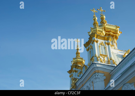 Gilded domes of orthodox church of palace complex in Petergofe on a background sky.