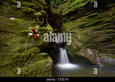 Ribbons and trinkets on the rock walls by Saint Nectan's Kieve in Saint Nectan's Glen, thought by many to be a sacred place. Stock Photo