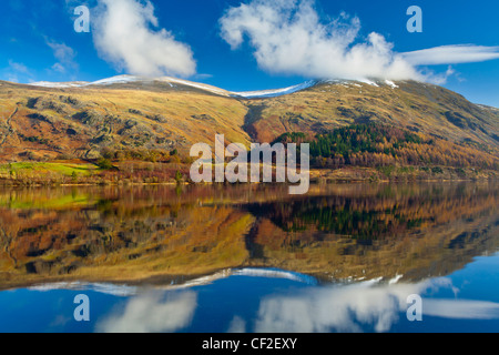 Lakeland hills reflected upon the still face of the Thirlmere Reservoir in the Lake District National Park. Stock Photo