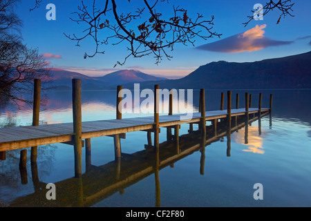 Brandelhow Jetty reflected in the still water of Derwentwater in the Lake District National Park. Stock Photo