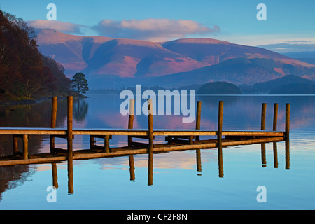 Brandelhow Jetty reflected in the still water of Derwentwater in the Lake District National Park. Stock Photo