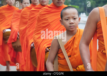 Monks collecting morning alms, Luang Prabang, Laos Stock Photo