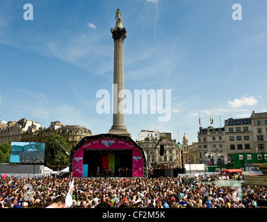 Large crowd of people enjoying a party atmosphere at a concert in Trafalgar Square as part of Pride London Parade. Stock Photo