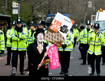 A woman holding a placard and demonstrating during the G20 summit in London. Stock Photo