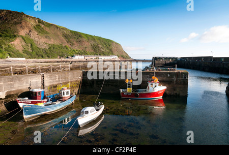 Boats in the small fishing harbour at Burnmouth, the first village in Scotland on the A1 after crossing the border with England. Stock Photo