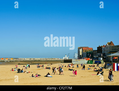 People enjoying the sunshine on the sandy beach at Margate. Stock Photo