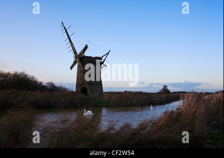 A view of Brograve Drainage Mill at dusk on the Norfolk Broads near Horsey, Norfolk, England, United Kingdom. Stock Photo