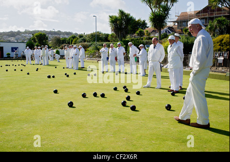 Bowlers dressed in white playing Crown Green Bowls at Newlyn Bowling Club. Stock Photo