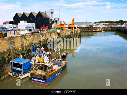 Fishing boats moored in the harbour at Whitstable. Stock Photo