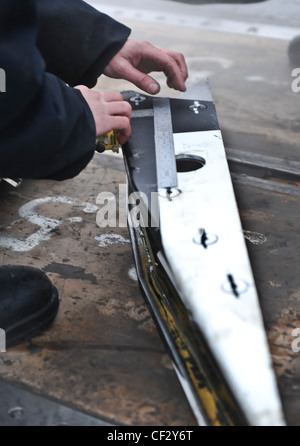 BREMERTON, Wash. (Feb. 28, 2012) – Airman Apprentice Mccord Brickle performs maintenance on a waist catapult shuttle on the flight deck of the aircraft carrier USS Nimitz (CVN 68). The maintenance is part of Nimitz’ continuing effort to prepare for sea. Nimitz is making final preparations to return to sea. Stock Photo