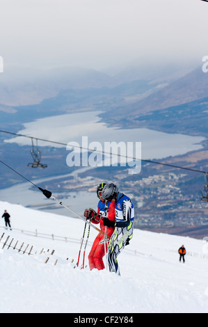 skiers on uplift button tow at nevis range fort william scottish Highlands UK during winter Stock Photo