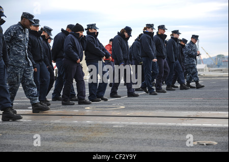 BREMERTON, Wash. (Feb. 28, 2012) – Sailors aboard the aircraft carrier USS Nimitz (CVN 68) take part in a foreign object debris (FOD) walk-down of the flight deck. FOD walk-downs ensure the safety of personnel and equipment while keeping Nimitz in a constant state of readiness to receive aircraft. Nimitz is making final preparations to return to sea. Stock Photo