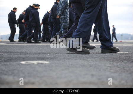 BREMERTON, Wash. (Feb. 28, 2012) – Sailors aboard the aircraft carrier USS Nimitz (CVN 68) take part in a foreign object debris (FOD) walk-down of the flight deck. FOD walk-downs ensure the safety of personnel and equipment while keeping Nimitz in a constant state of readiness to receive aircraft. Nimitz is making final preparations to return to sea. Stock Photo