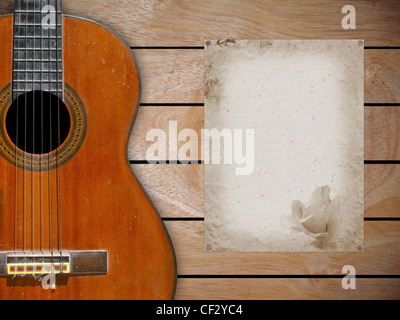 Classical guitar on wood fragment wall with blank page of mulberry paper for some note Stock Photo