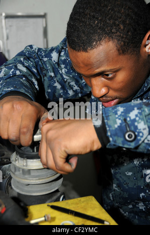 BREMERTON, Wash. (Feb. 28, 2012) – Aviation Boatswain’s Mate (Fuel) Airman Adrian Davis inspects the nozzles of the fuel lines used to refuel aircraft. Nimitz is conducting a fast cruise for returning to sea for the first time since the ship’s Docked Planned Incremental Availability. The ship arrived to Bremerton, Wash. to begin its DPIA December 2010. Stock Photo