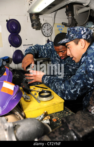 BREMERTON, Wash. (Feb. 28, 2012) – Aviation Boatswain’s Mate (Fuel) Airman Adrian Davis inspects the nozzles of the fuel lines used to refuel aircraft. Nimitz is conducting a fast cruise for returning to sea for the first time since the ship’s Docked Planned Incremental Availability. The ship arrived to Bremerton, Wash. to begin its DPIA December 2010. Stock Photo