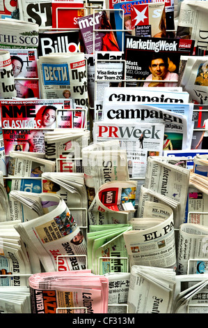A selection of international newspapers and publications on a stand. Stock Photo