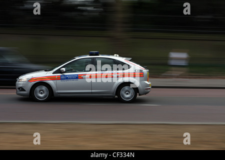 A metropolitan police car traveling along a road in London Stock Photo