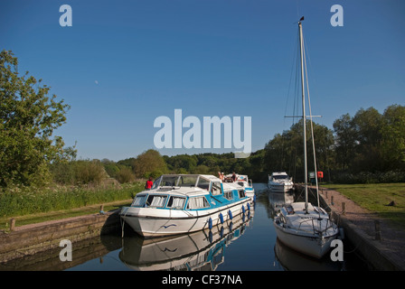 People relaxing on a boating holiday on the River Yare on the Norfolk Broads. Stock Photo