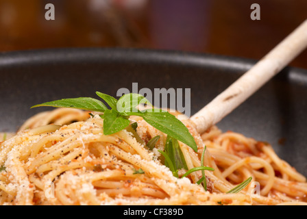 Serving some freshly prepared spaghetti in tomato sauce Stock Photo