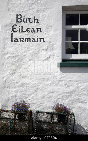 Exterior view of traditional text on the side of a Gaelic shop at Isleornsay. Stock Photo