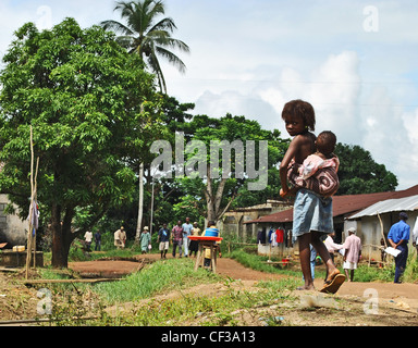 A girl carrying her sister in Kenema, Sierra Leone