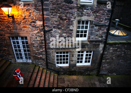 Looking down on the street to a person  in costume during the Edinburgh Christmas Santa Stroll. Stock Photo