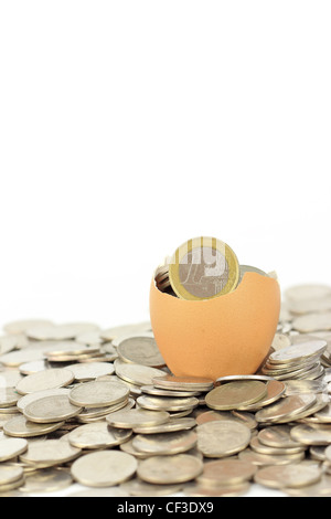 Broken eggshell on coins Stock Photo