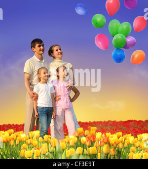 family of four in tulip field and balloons collage Stock Photo