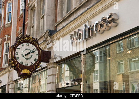 Close up of the old clock outside Waitrose in Marylebone High Street. Stock Photo