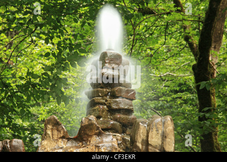 Stone fountain in wood Stock Photo