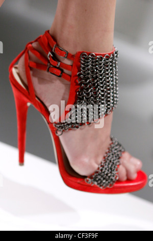 Versus Milan Ready to Wear Spring Summer Red stiletto shoes with metal chains detail and ankle straps Stock Photo