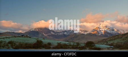 A view of pink clouds surrounding the peak of Mount Snowdon from Capel Curig. Stock Photo