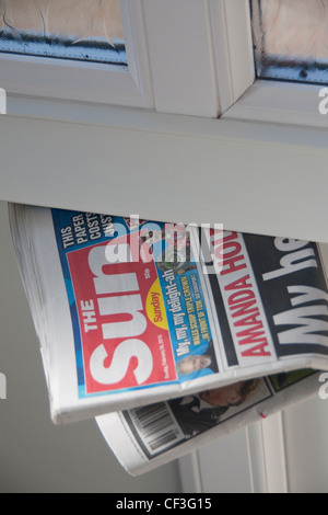 First edition of The Sun on Sunday tabloid newspaper February 26th 2012 pushed through letterbox Stock Photo