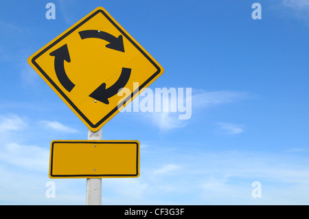 Blank yellow road sign on blue sky with clouds. Stock Photo