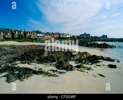 A view along the shore of St Ronan's Bay from the jetty at Baile Mor, showing the main village street with the abbey beyond. Stock Photo