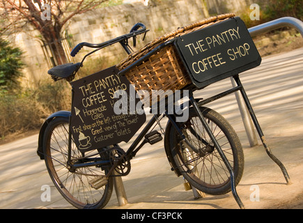 An old delivery bicycle in St Georges Park advertising The Pantry Coffee Shop. Stock Photo