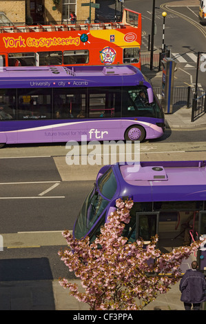 First York FTR buses and an open top double decker sightseeing bus outside York railway station. Stock Photo