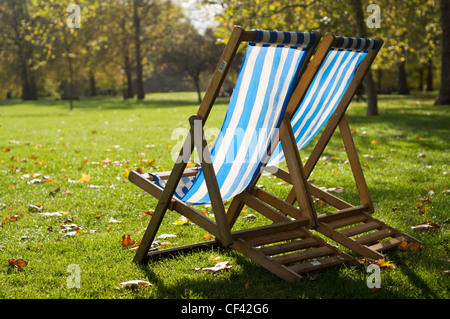 two empty deck chairs in a park Stock Photo - Alamy