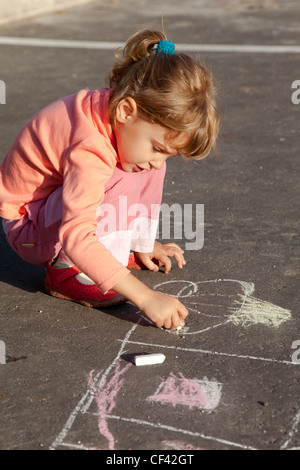 girl sits concrete asphalt square road girl draws painting line house chalk asphalt chld drawings paintings asphalt concrete Stock Photo