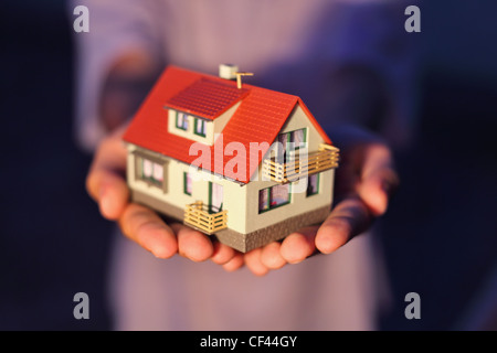 model of house on hands Stock Photo