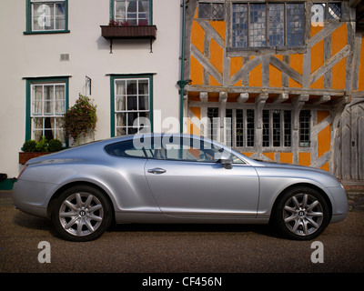 A modern Bentley motor car parked in front of timber framed buildings. Although built in Crewe and assumed to be a quintessentia Stock Photo