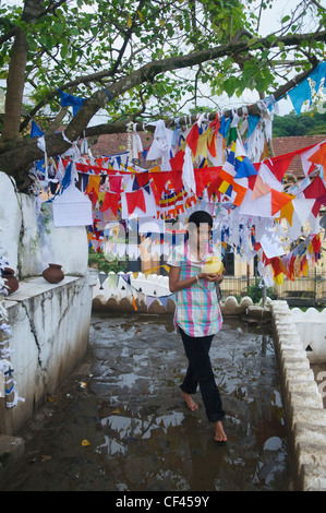 praying for luck at the Natha Devale shrine in Kandy, Sri Lanka Stock Photo