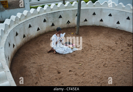 praying for luck at the Natha Devale shrine in Kandy, Sri Lanka Stock Photo