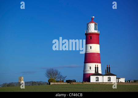 A view toward Happisburgh Lighthouse. It is the oldest working light in East Anglia and the only independently run lighthouse in Stock Photo